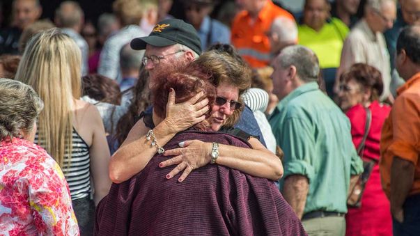 Family and friends mourn following the funeral service of Margaret Louisa Clark (82), the second person to die from injuries of the Ravenshoe "Serves You Right Cafe" gas explosion. (AAP)