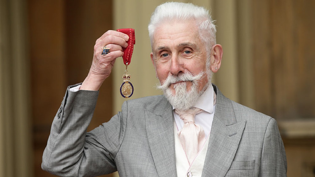 A longtime royal writer says he 'hid the Queen Mother's racism'