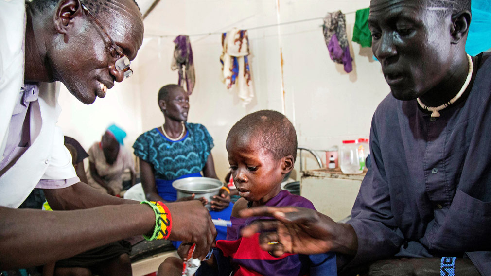 A medical officer from Doctors Without Borders attends to a child with malnutrition in a clinic in Old Fangak Jonglei state South Sudan