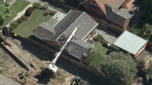 Drill rig topples onto Melbourne home