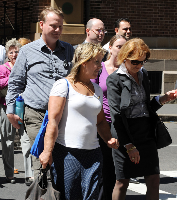 Chris (left) and Mandy Burgess (centre) leave the King Street courts after listening to the first day of evidence into the stabbing murder of their 15-year-old daughter Tania Burgess, Sydney, Monday, March 10, 2008.