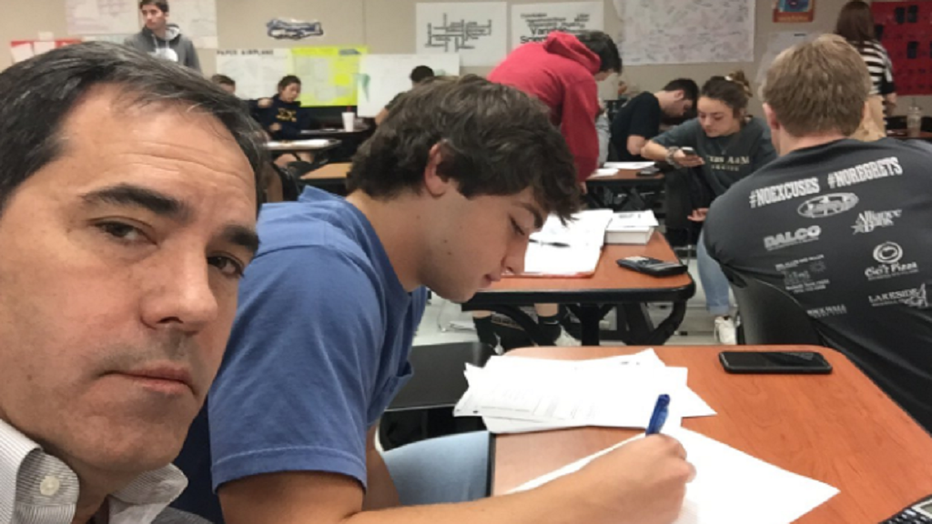 Dad sits with son in class after bad behaviour