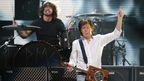 Dave Grohl (background) with Sir Paul McCartney. (Getty)