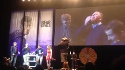John Key eats bugs at a Bear Grylls show in Auckland.