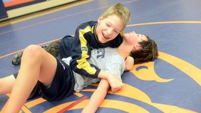 Jared Stevens (left) wrestles with Eli Copeland during practice at Sunset Middle School.