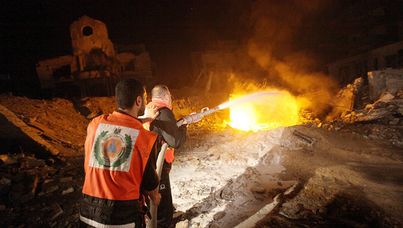 Palestinian firefighters tackle a blaze at a destroyed Hamas site after an Israeli air strike hit an area south of Gaza City.