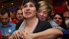 Lauren Snead hugs her partner Katy Jayne as they celebrate the legalisation of same-sex marriage in Maine. (AAP)