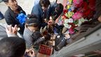 People buy candles, flashlights and supplies at a small New York shop after Hurricane Sandy had passed.