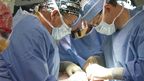 Dr Julian Pribaz and Dr Bohdan Pomahac of the Brigham and Women's Hospital Department of Plastic Surgery in Boston, Massachusetts replacing the soft facial tissues of Mitch Hunter. (AAP)