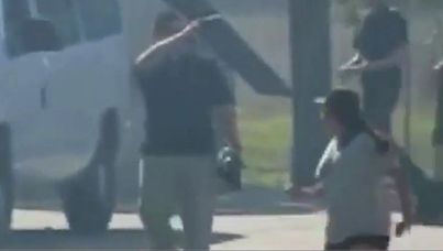 A student in the video runs from one of the fake gunmen.