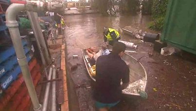 Rescuers help evacuate Bundaberg residents. (Nine News)