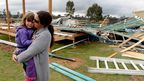 Melissa Short and her four-year-old daughter Ayla stand next to the ruins of their near completed house in the township of Pratten, near Warwick, Queensland.