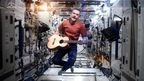 Canadian astronaut Chris Hadfield performs a revised version of David Bowie's song 'Space Oddity' aboard the International Space Station.