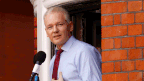 WikiLeaks founder Julian Assange making a statement to the media and supporters at a window of Ecuadorian Embassy in central London in 2012. (AAP)