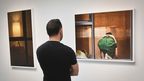 A visitor views the photography of Arne Svenson. (AAP)
