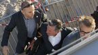 French actor Daniel Auteuil and Oscar winner Christoph Waltz are rushed from the set of the show. (Getty)
