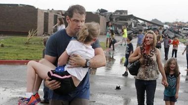 Bloodied teachers take children away from destroyed Briarwood Elementary School in Moore, Oklahoma.