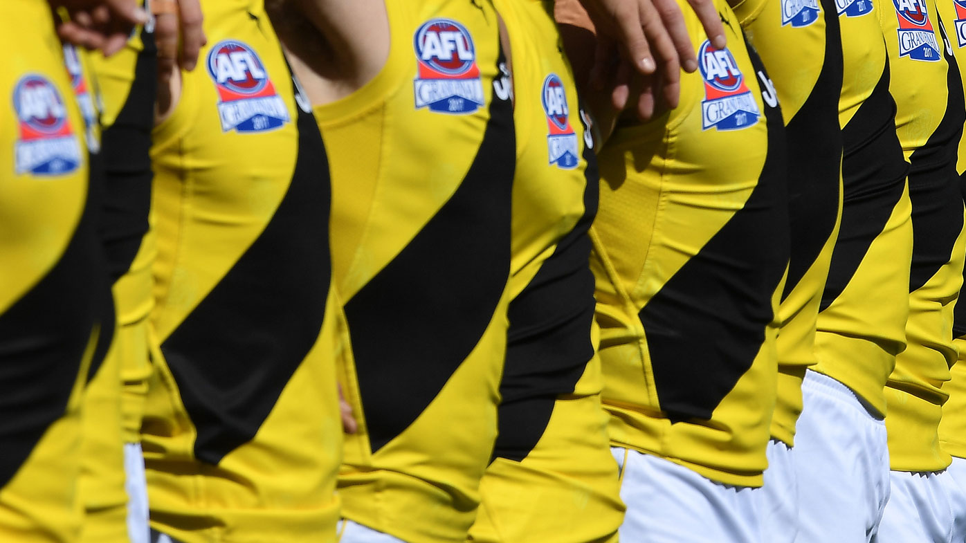 Richmond player behind topless photo returns home after AFL announce probe