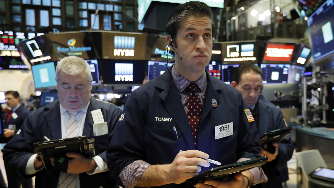 Thomas Donato, center, works with fellow traders on the floor of the New York Stock Exchange.