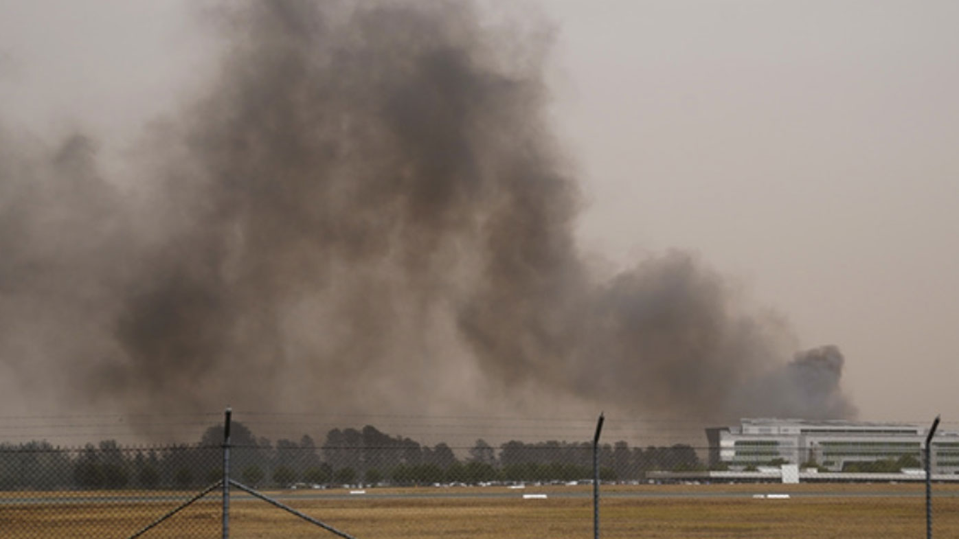 Flights in and out of Canberra airport have been grounded as two bushfires burn in the ACT.