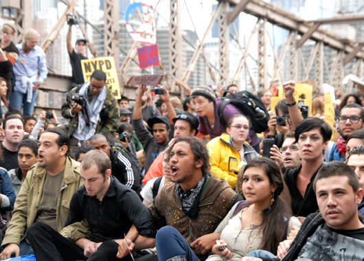 arms linked on New York's Brooklyn Bridge before police began making arrests during a march by Occupy Wall Street. (AAP)