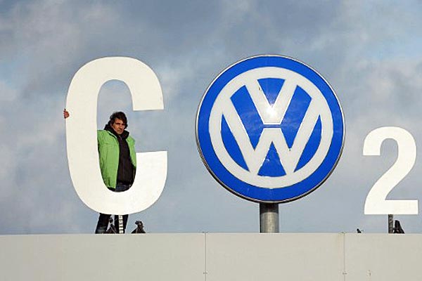Greenpeace activists stand with 'CO2' formed with the VW logo above the Volkswagen factory gate in Wolfsburg, Germany. (AFP)