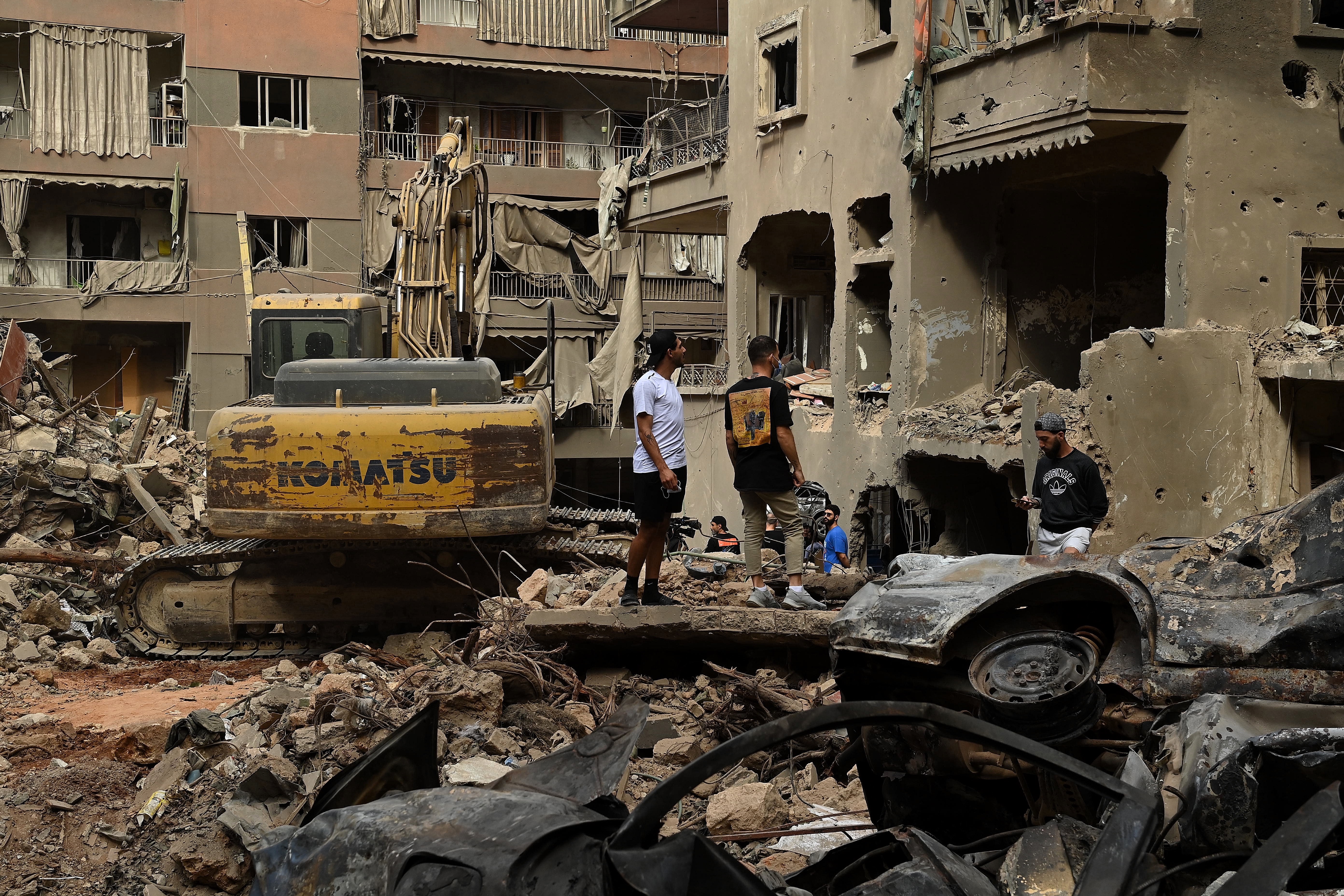 El BASTA AIRSTRIKE STORY Two men stand on the top of debris at the site of the October 10 Israeli airstrike in Beiruts el-Basta suburb that killed 22 people and injured 117 people. Beirut, Lebanon. October 12, 2024. Photo: Kate Geraghty