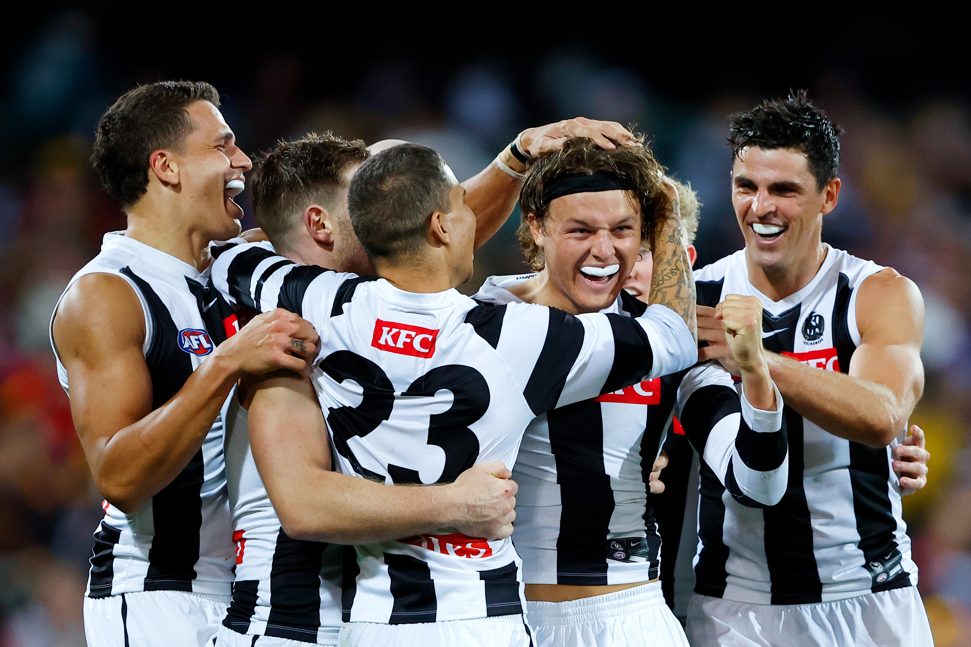 Jack Ginnivan of the Magpies celebrates a goal with teammates during the 2023 AFL Round 05 match between the Collingwood Magpies and the St Kilda Saints at Adelaide Oval on April 16, 2023 in Adelaide, Australia. (Photo by Dylan Burns/AFL Photos)