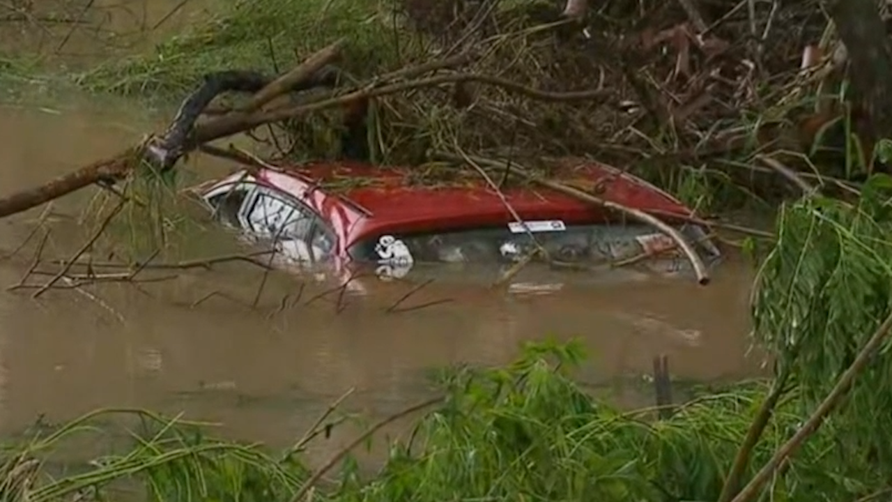 A man has died after his car became submerged in floodwaters. 