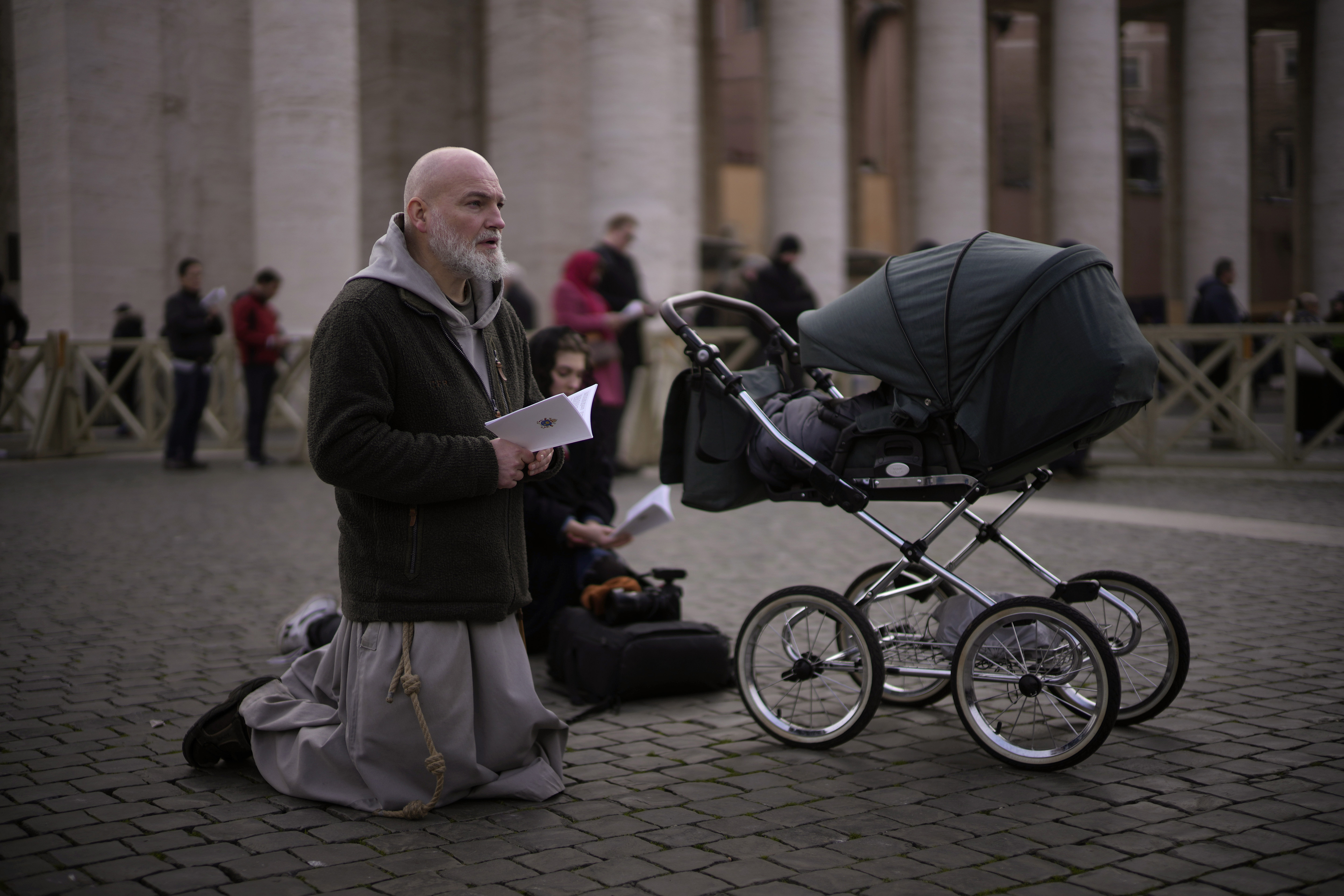 Faithful attend the funeral mass for late Pope Emeritus Benedict XVI in St. Peter's Square at the Vatican, Thursday, Jan. 5, 2023. Benedict died at 95 on Dec. 31 in the monastery on the Vatican grounds where he had spent nearly all of his decade in retirement. (AP Photo/Domenico Stinellis)