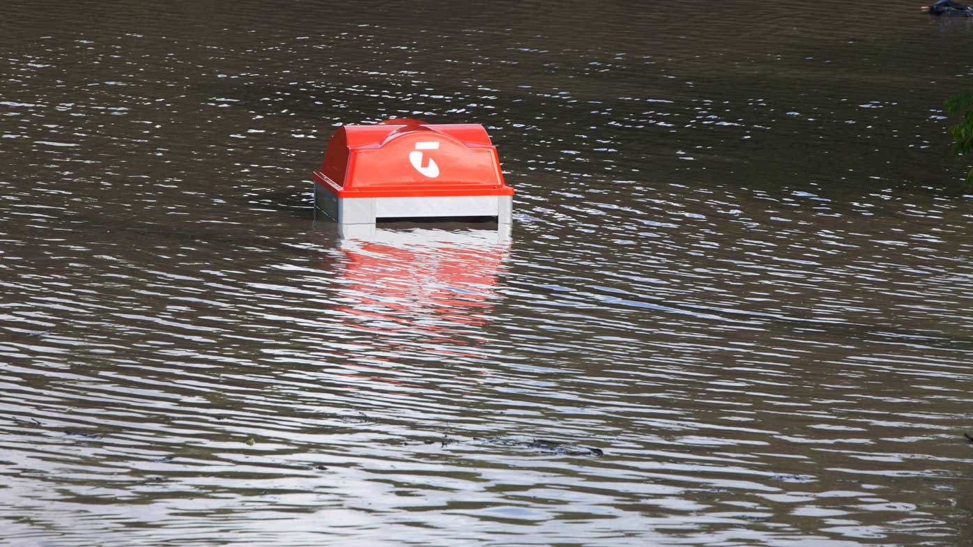 A phone booth in the suburb of Fairfield is inundated by the floodwaters.