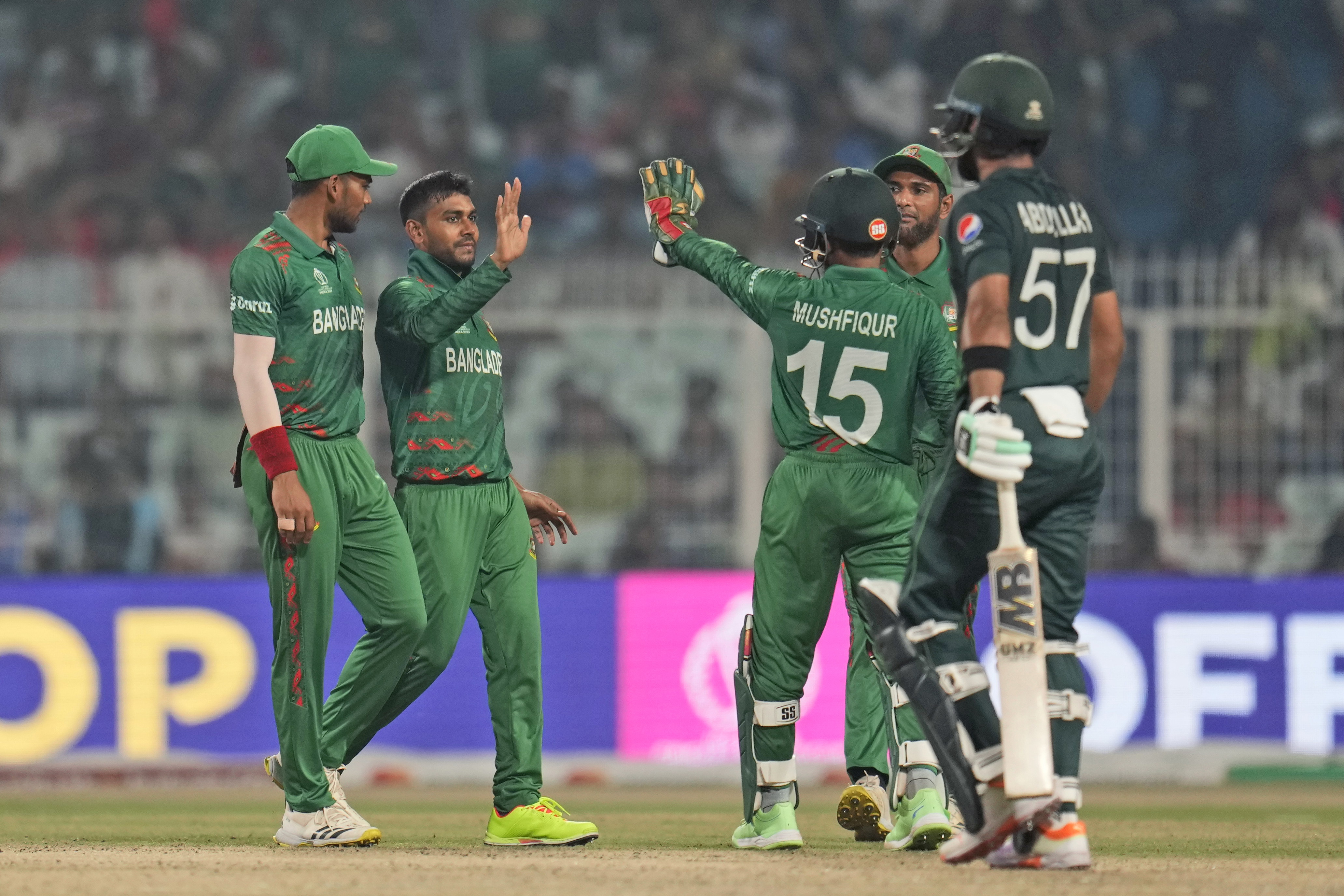 Bangladesh's Mehidy Hasan Miraz celebrates with teammates the wicket of Pakistan's Abdullah Shafique.