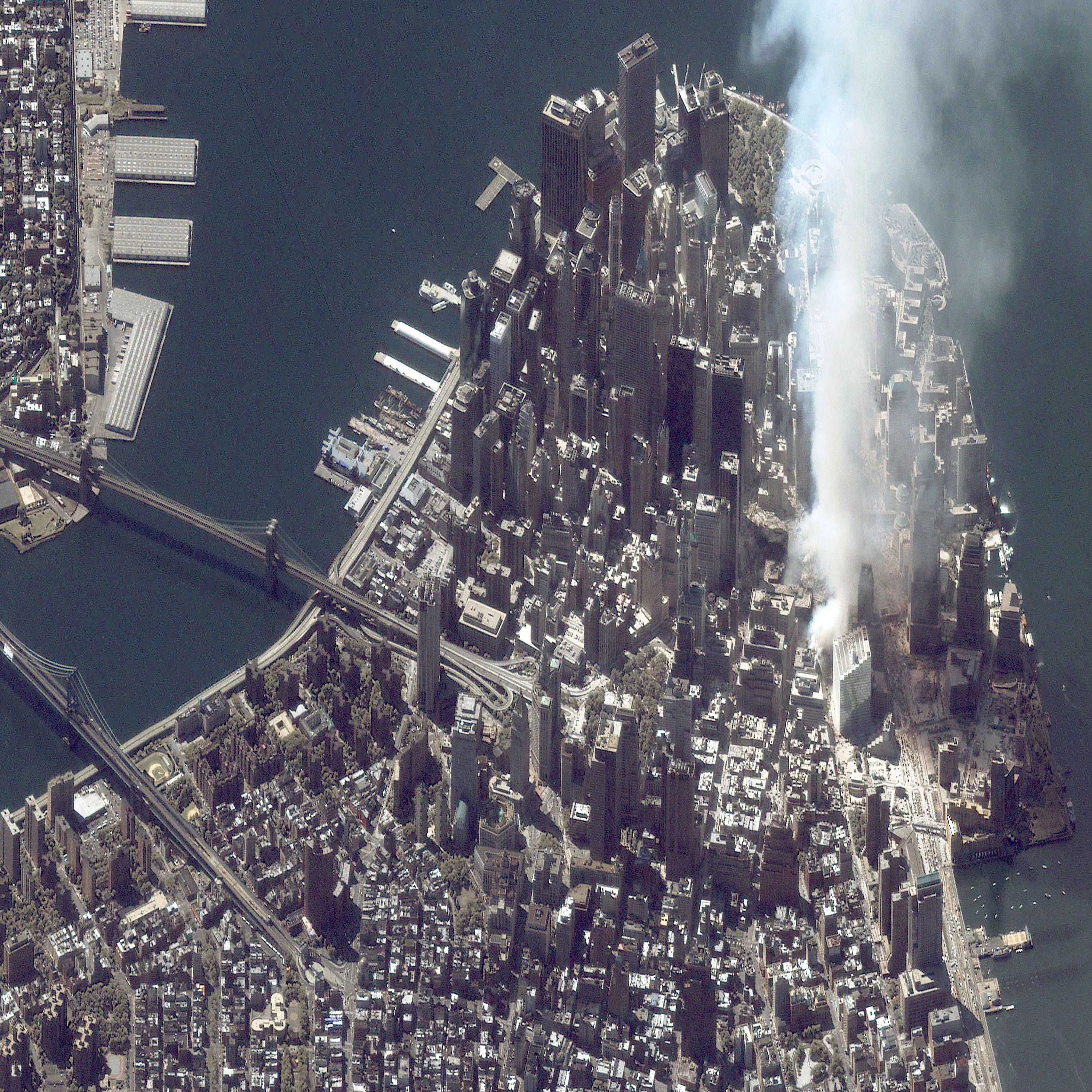 A satellite image of lower Manhattan shows smoke and ash rising from the site of the World Trade Center the day after the September 11 attacks.