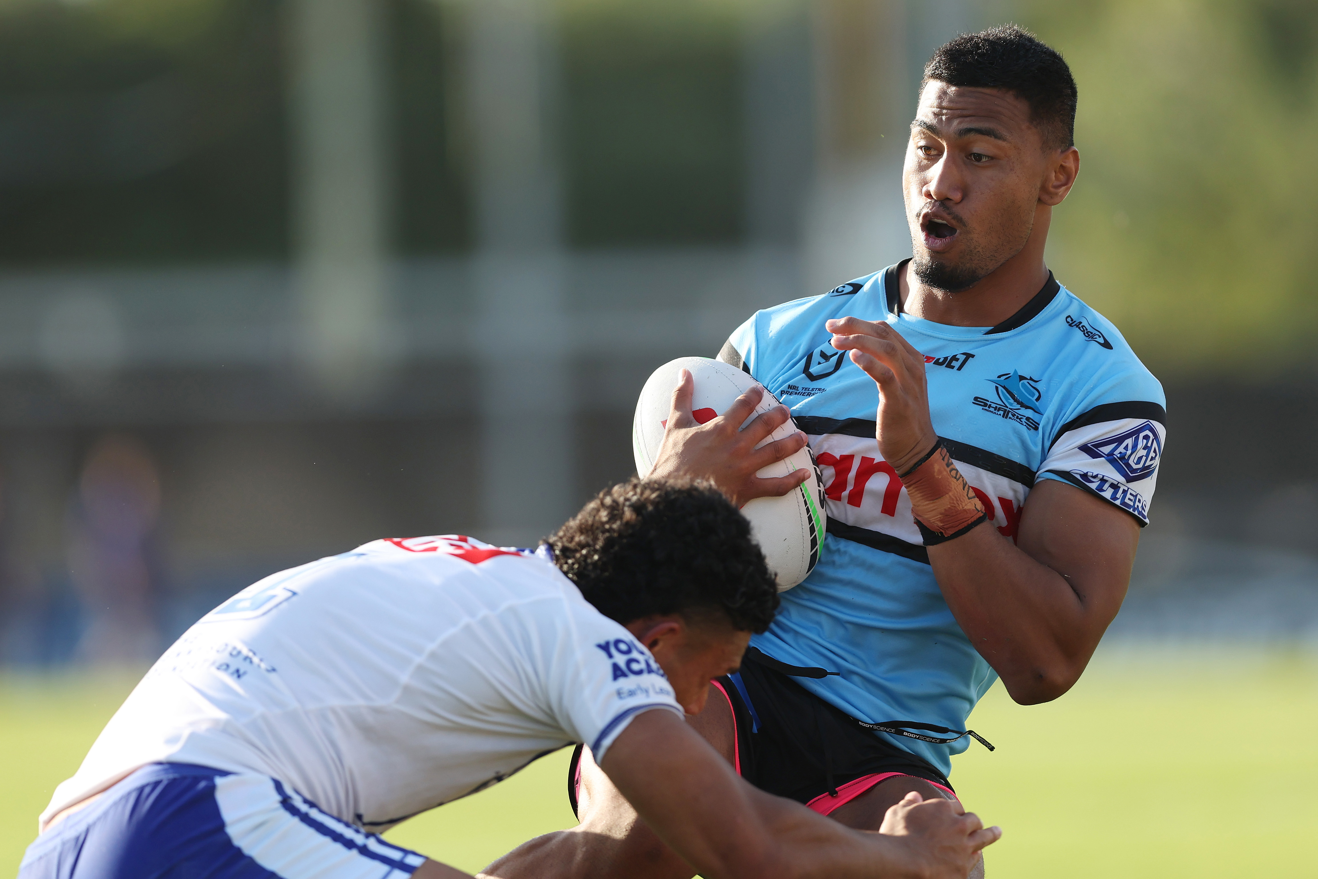 Ronaldo Mulitalo of the Sharks is tackled.