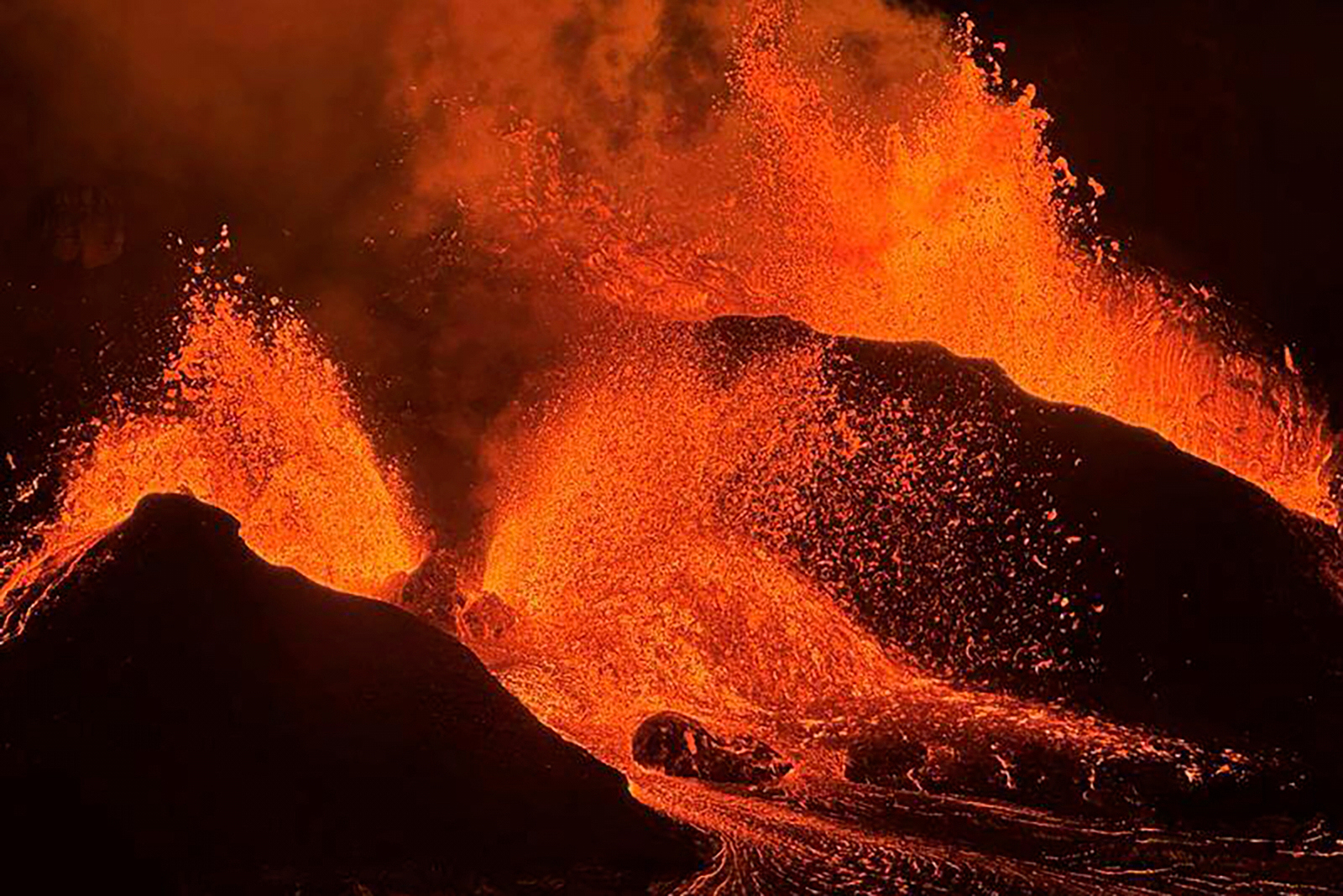 FILE - This image provided by the U.S. Geological Survey (USGS) shows evening views of lava fountaining from Haleumaumau Crater at the summit of Kilauea volcano inside Hawaii Volcanoes National Park, Hawaii., Feb. 11, 2025. (M. Patrick/U.S. Geological Survey via AP)