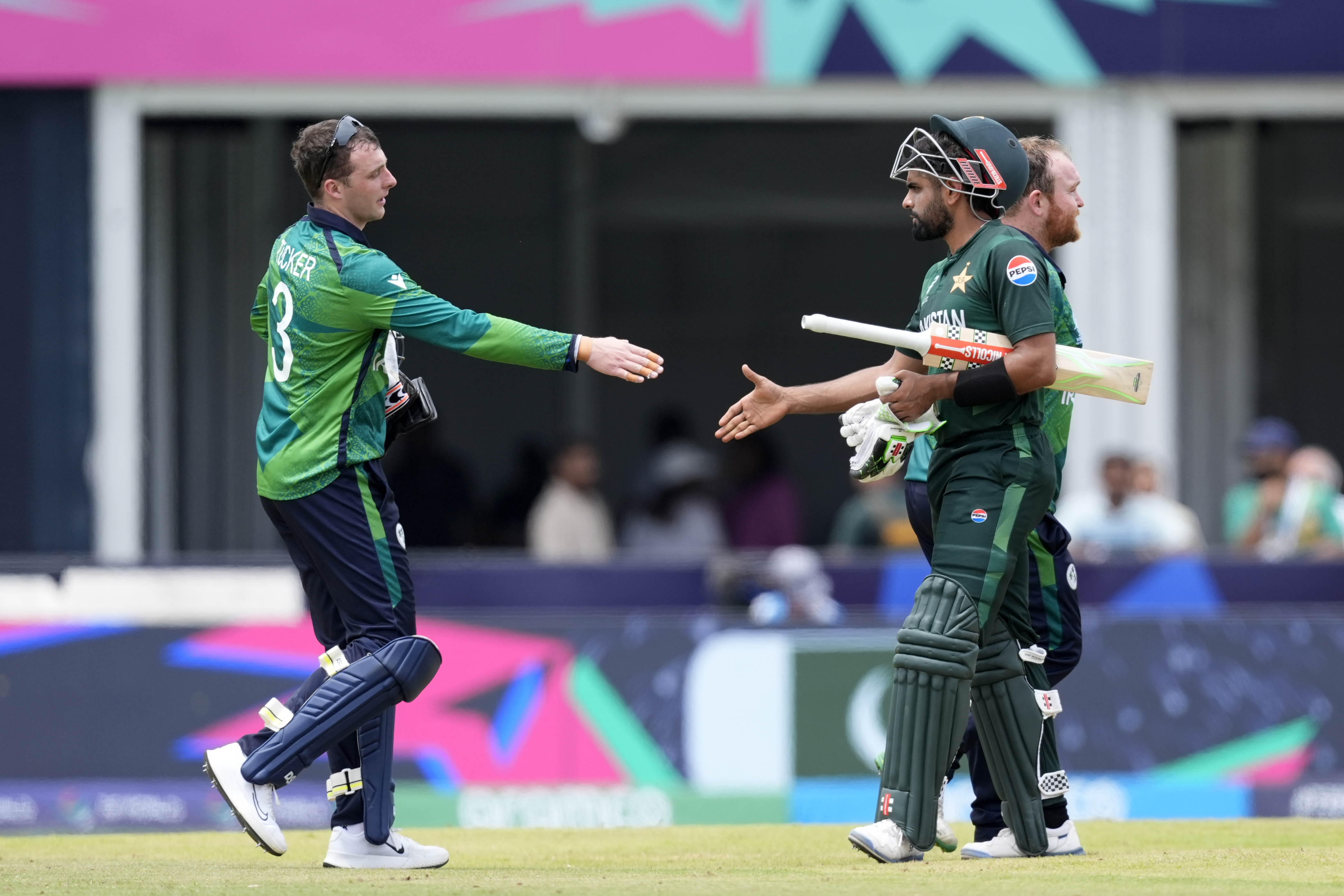 Ireland's Lorcan Tucker (left) congratulates Pakistan's captain Babar Azam (right).