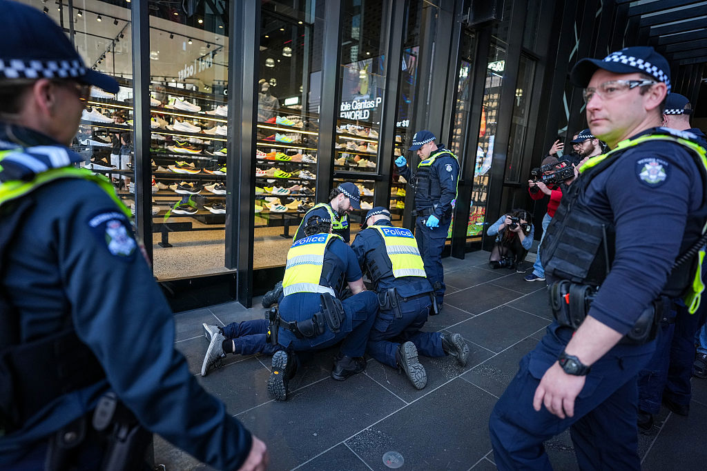 MELBOURNE, AUSTRALIA - AUGUST 03: Police detain counter-protesters during a march in support of Palestinians on August 03, 2025 in Melbourne, Australia. Protesters in Sydney and Melbourne joined marches and actions globally, as pressure mounts on the Israeli government over a devastating humanitarian crisis unfolding as its war against Hamas continues. (Photo by Asanka Ratnayake/Getty Images)