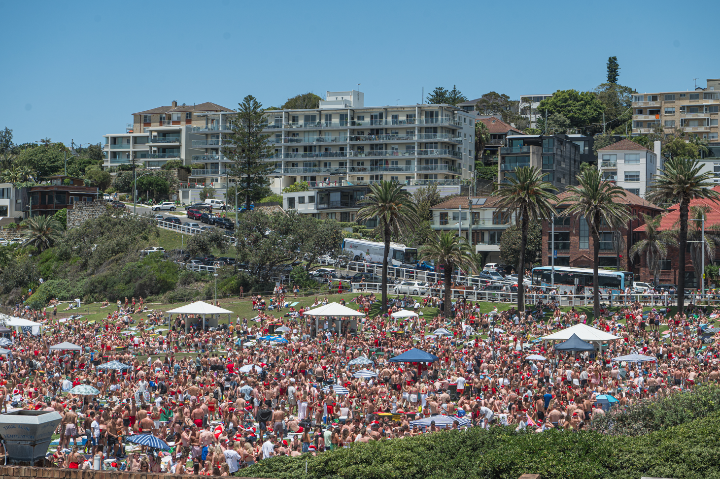 People celebrate Christmas Day at Bronte Beach in 2023.