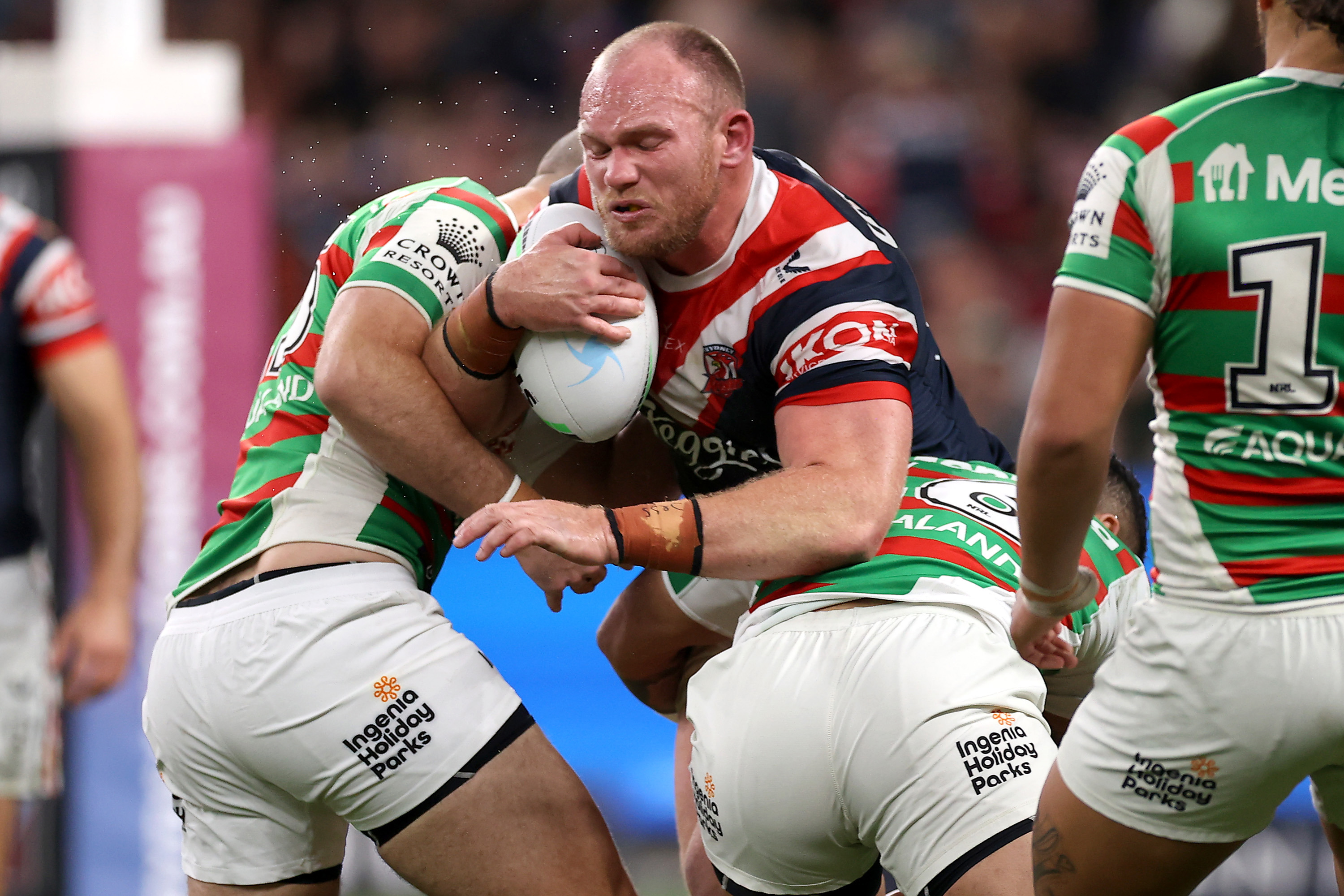 Matthew Lodge of the Roosters is tackled.