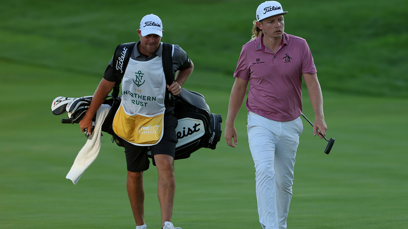 Cameron Smith walks up the first playoff hole with his caddie at the Northern Trust tournament in New York.
