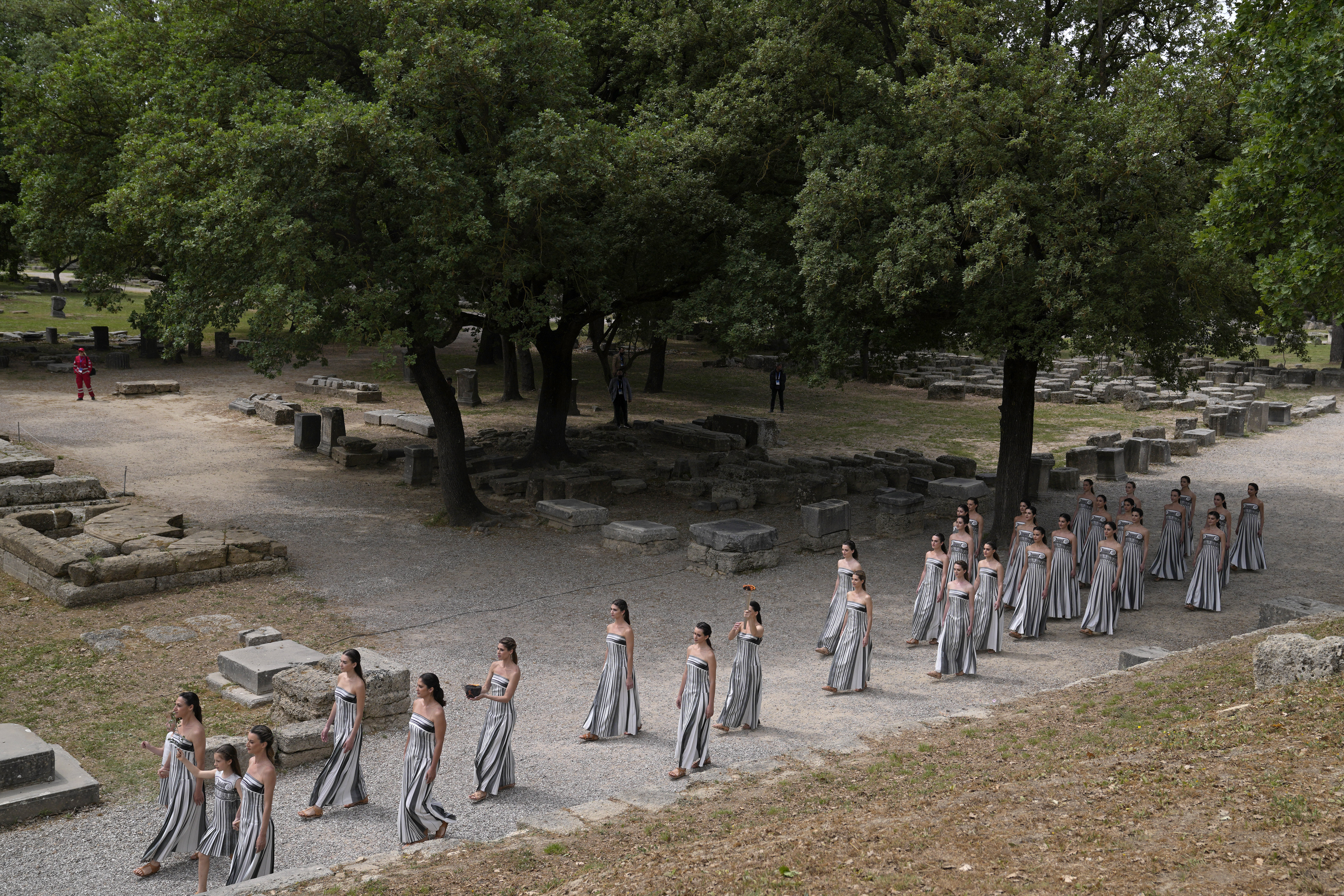 Performers take part in the official ceremony of the flame lighting for the Paris Olympics