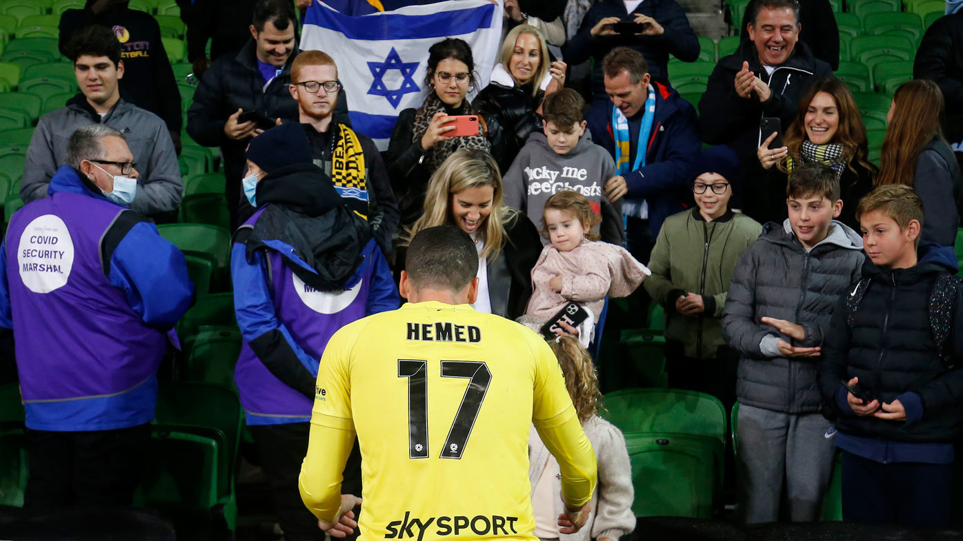 Tomer Hemed celebrates with fans. 