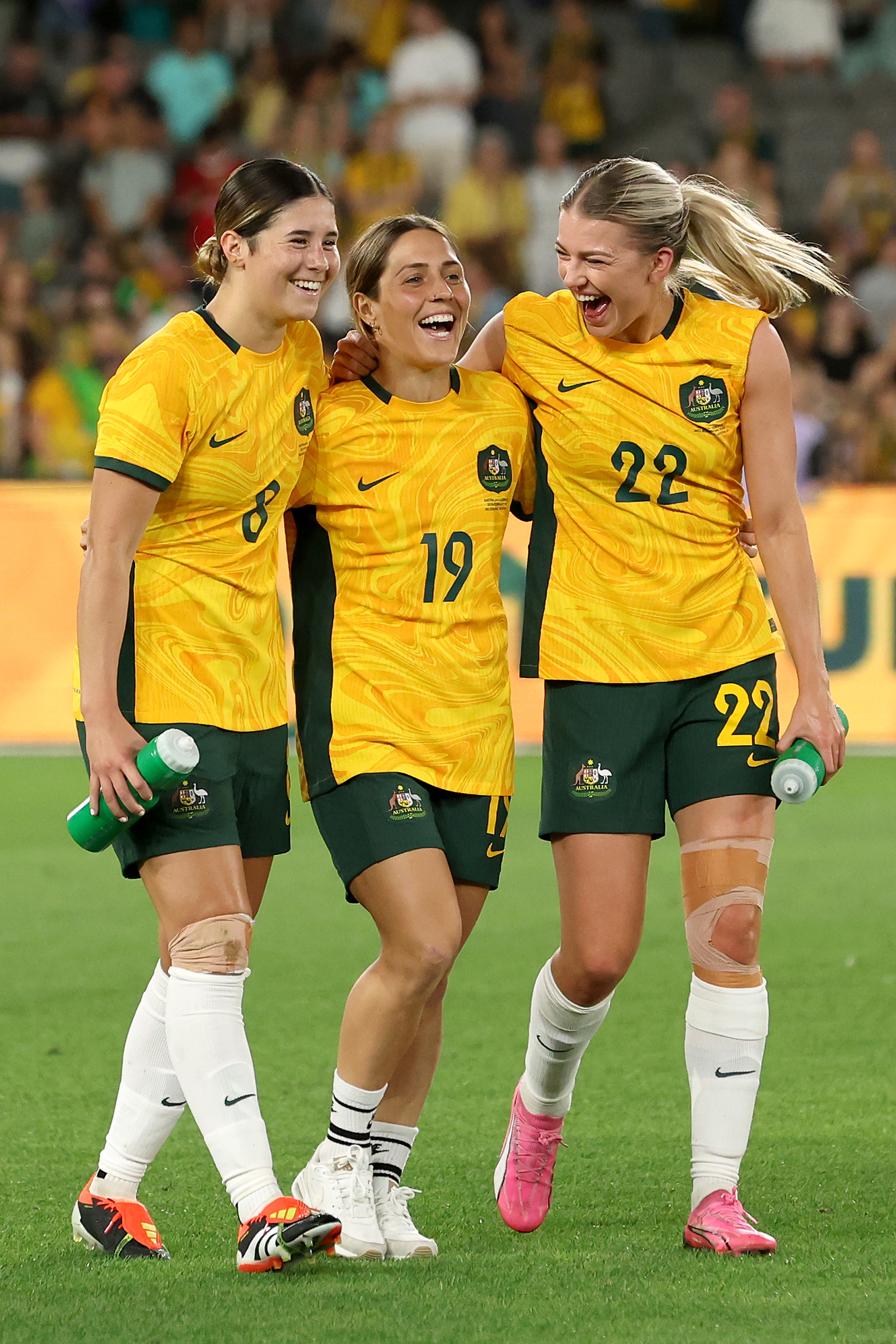 Kyra Cooney-Cross of Australia, Katrina Gorry of Australia and Charlotte Grant of Australia celebrate after winning the AFC Women's Olympic Football Tournament Paris 2024 Asian Qualifier Round 3 match between Australia Matildas and Uzbekistan at Marvel Stadium on February 28, 2024 in Melbourne, Australia.
