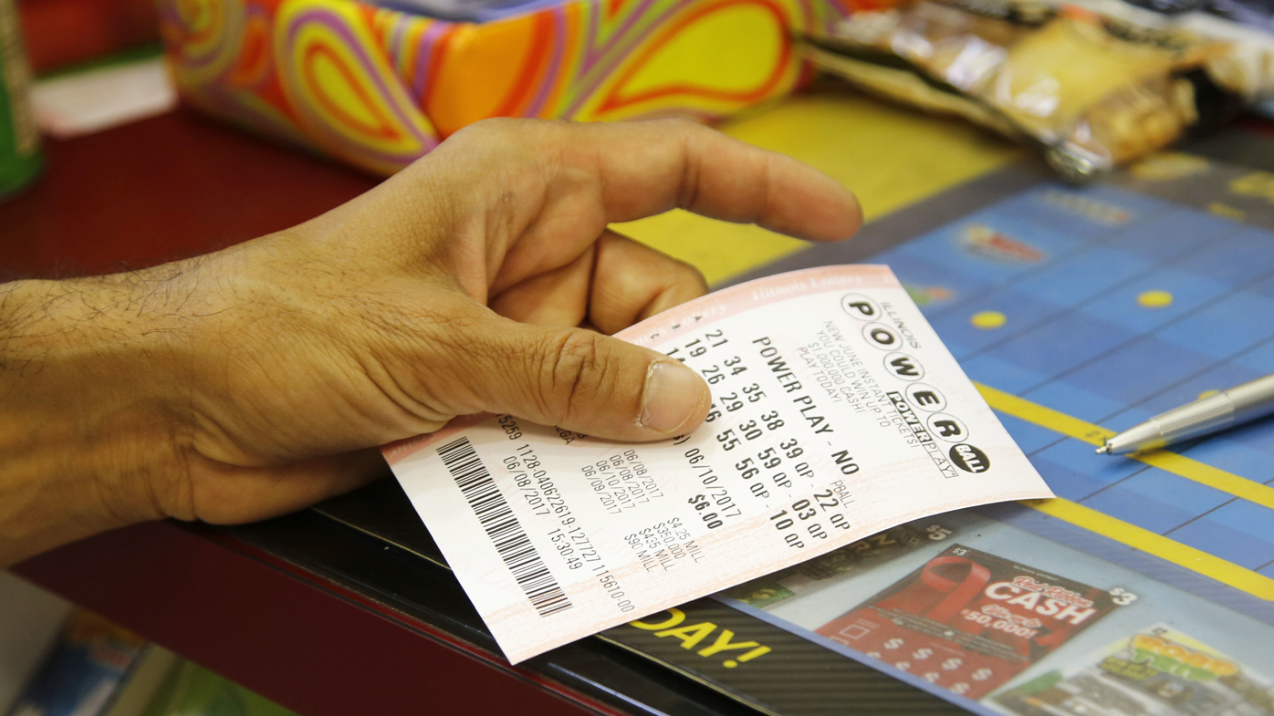 A customer buys a Powerball ticket, Thursday, June 8, 2017, in Chicago. The Powerball jackpot has grown up to $435 million, after more than two months without a winner. The jackpot for Saturday night's drawing would tie for the nation's 10th largest lottery prize. (AP Photo/G-Jun Yam)