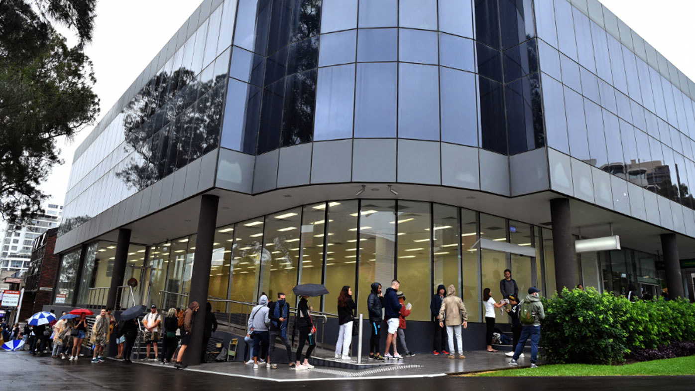 People are seen queuing outside a Centrelink office in Bondi Junction,