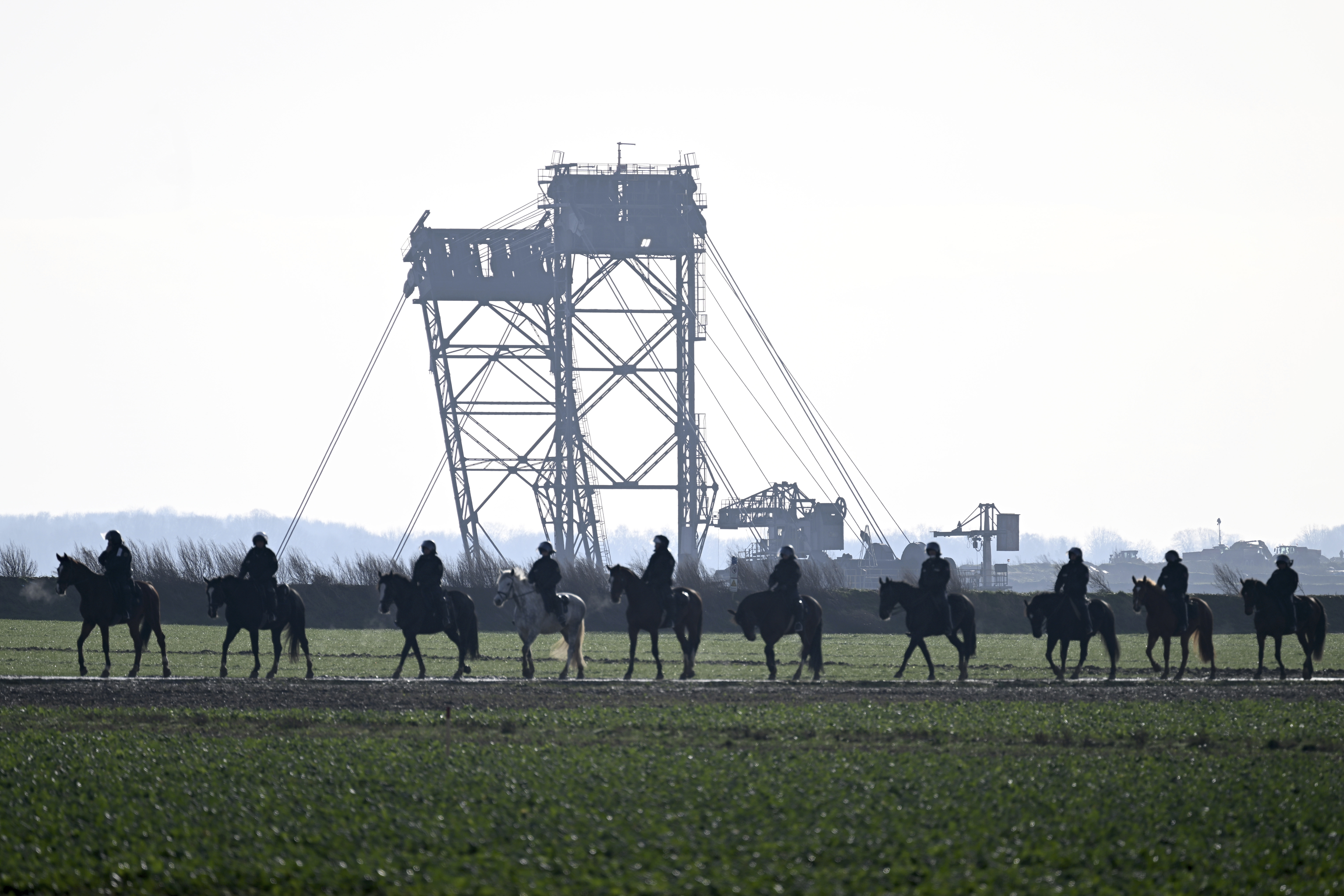 Mounted police observe a protest action of climate activists after the evacuation of Luetzerath, Germany, Tuesday, Jan. 17, 2023. 