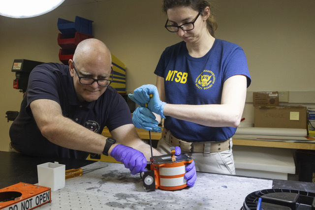 National Transportation Safety Board (NTSB) investigators examine cockpit voice recorder and flight data recorder 