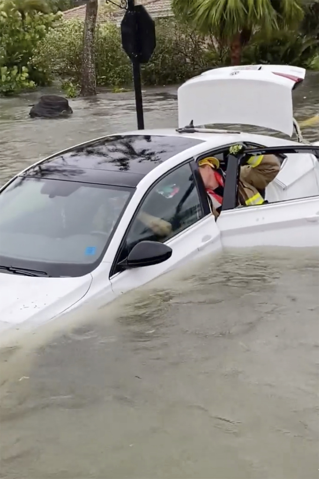 This photo provided by Naples Fire-Rescue Department crews help rescue a stranded motorist from flooding caused by Hurricane Ian on Wednesday, Sept. 28, 2022.