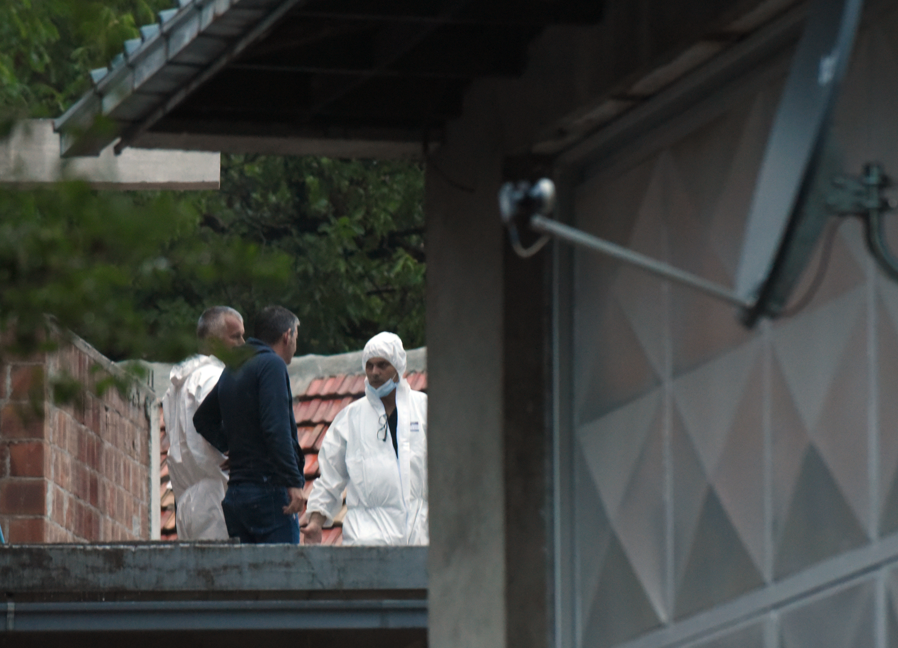 Police investigators on the site of the attack in Cetinje, 36 kilometres west of Podogrica, Montenegro, Friday, Aug. 12, 2022. A man in Montenegro went on a shooting rampage after a family dispute, killing 11 people on the streets of a city before being shot dead in a gun battle with police. (AP Photo/Risto Bozovic)