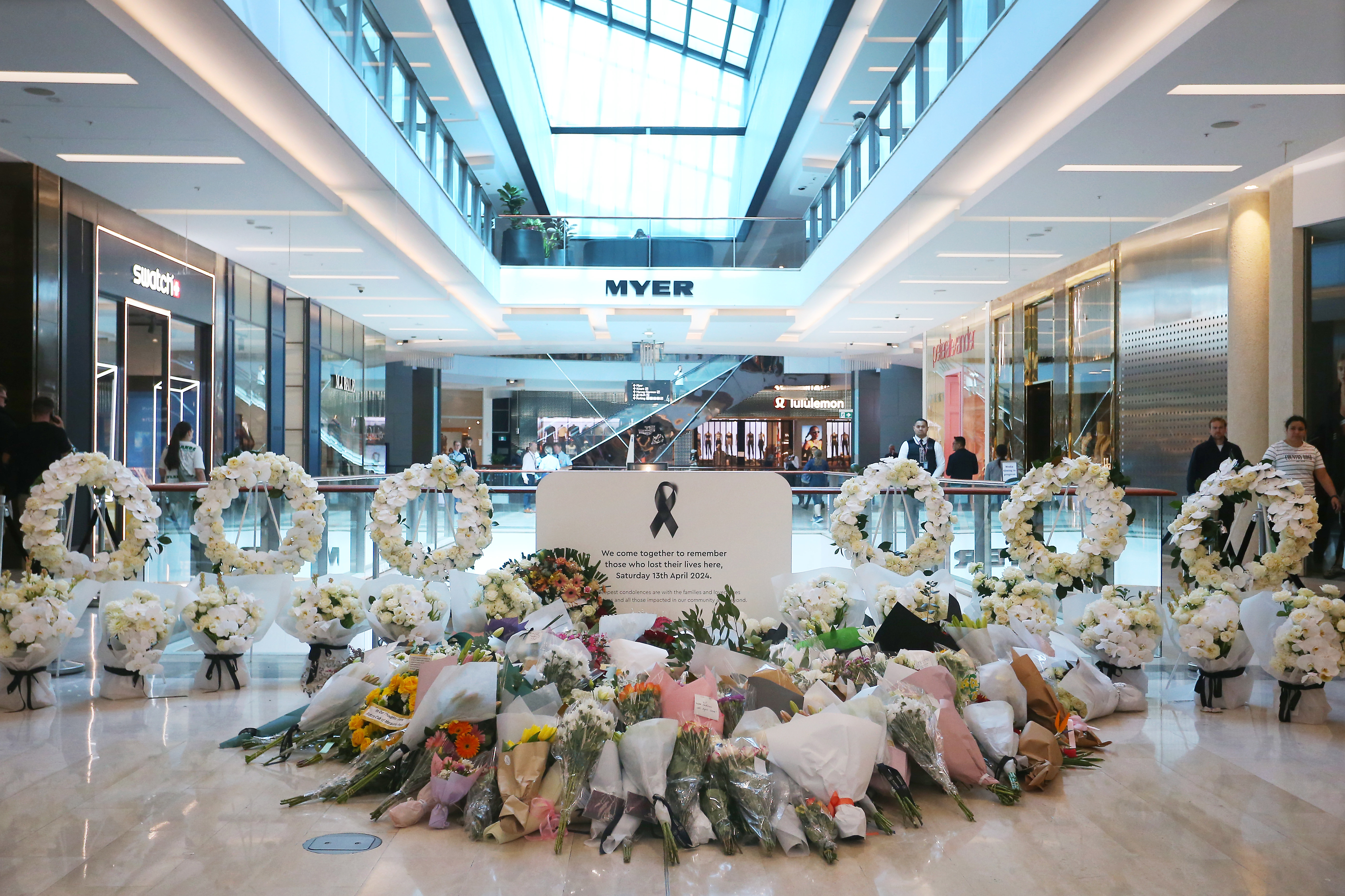 Floral tributes are seen at a memorial site during the re-opening of the Westfield Bondi Junction shopping centre on April 19, 2024 in Sydney, Australia